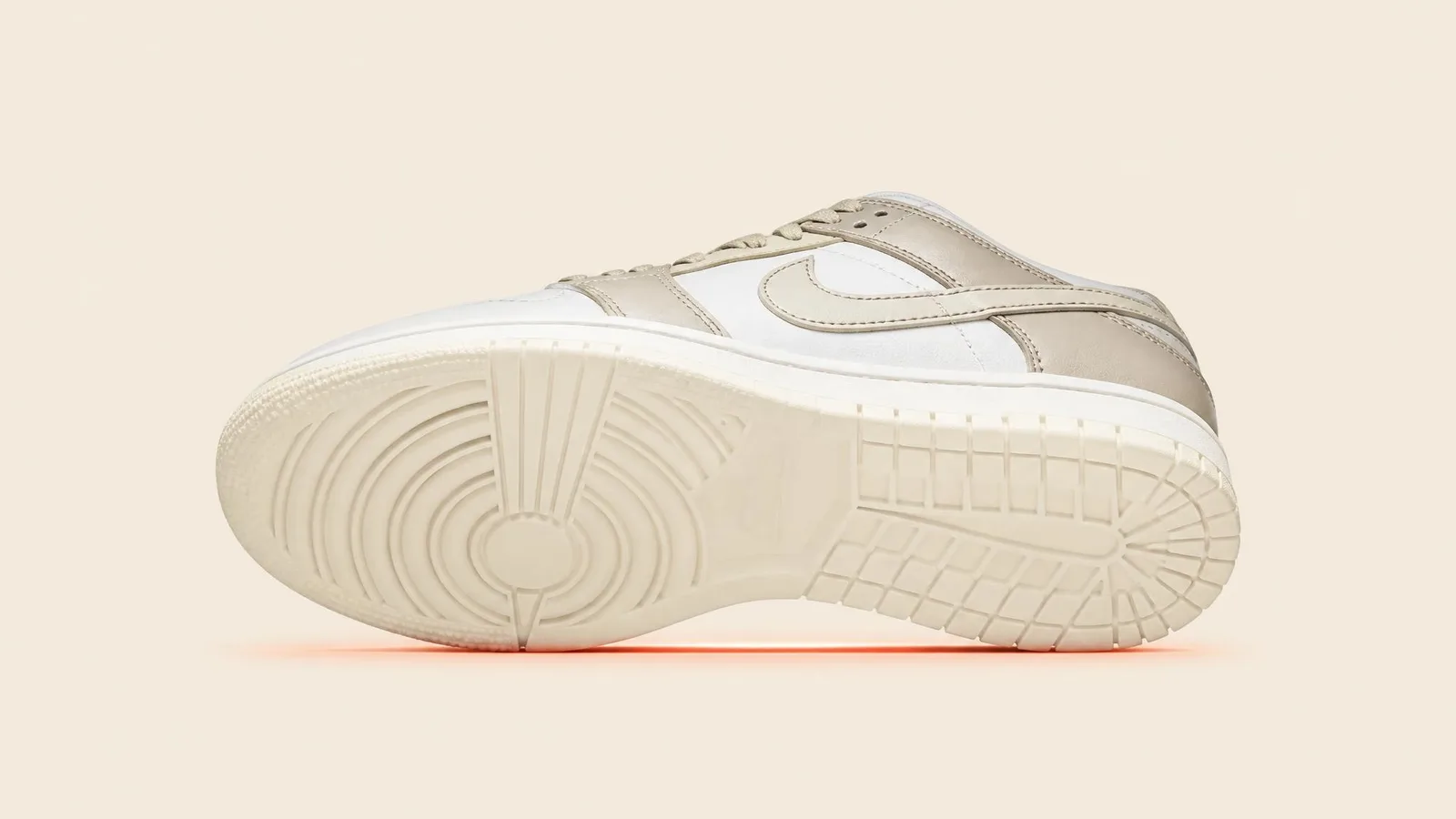 A pristine dead-stock sneaker photographed at a slight angle revealing a clean, unblemished sole and crease-free toe box against a warm off-white background, illustrating the importance of condition preservation for high-value pairs.