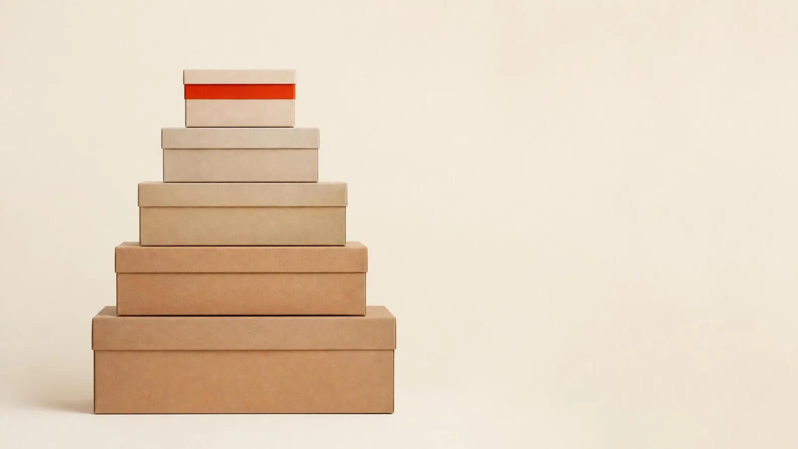Five sneaker shoeboxes stacked in a pyramid from largest at the base to smallest at the top, visually representing the five sneaker release scarcity tiers from general release to tier zero