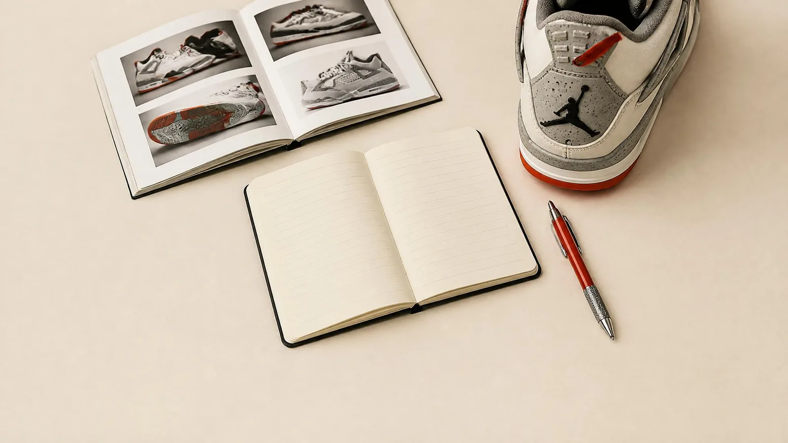 Flat-lay of a sneaker, open notebook, and pen on a warm off-white surface, representing the practice of recording release tier and collection details for each pair