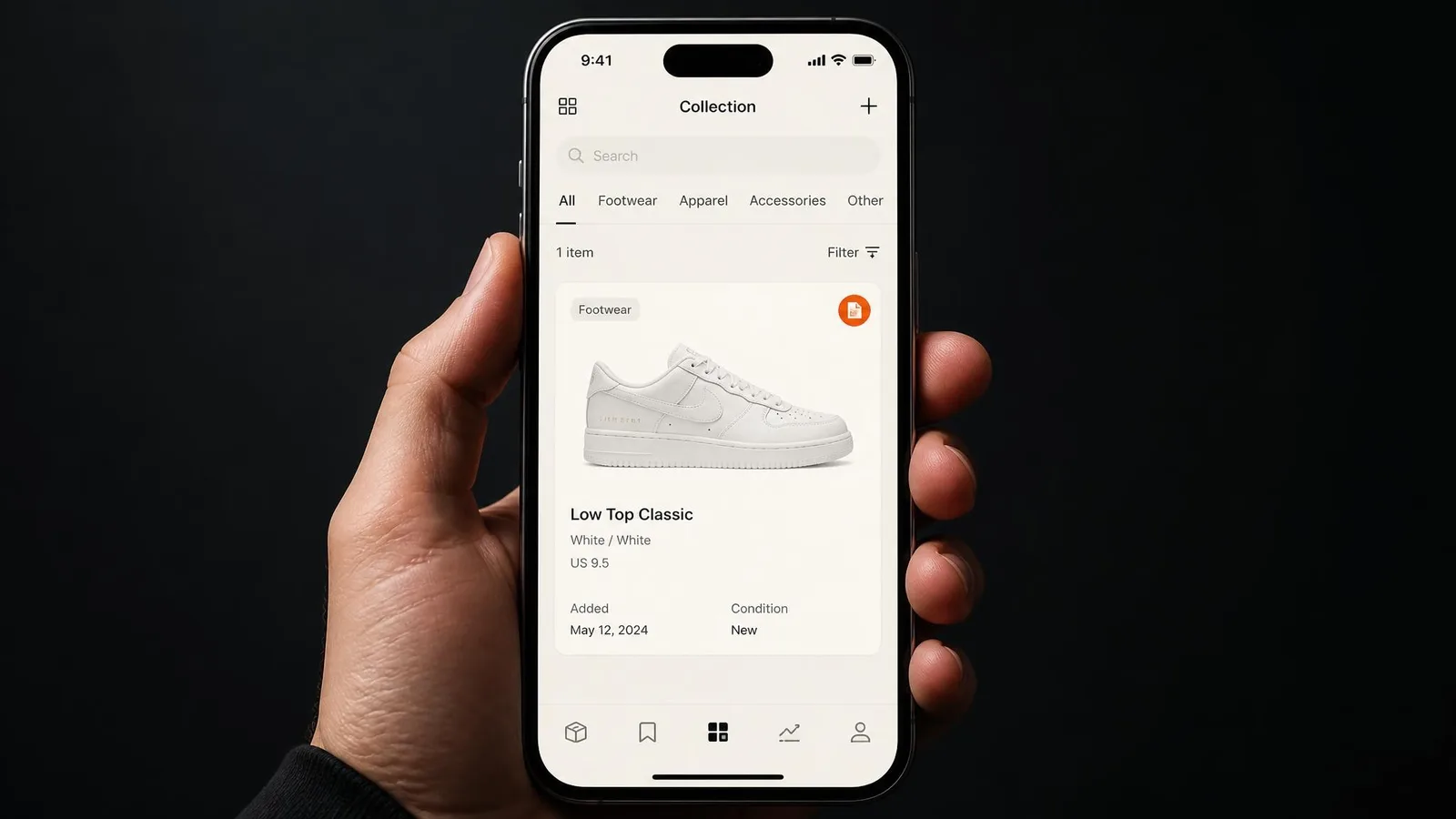 A hand holding a smartphone displaying a sneaker collection app interface with a single white sneaker entry and an orange verified badge, set against a dark near-black background.
