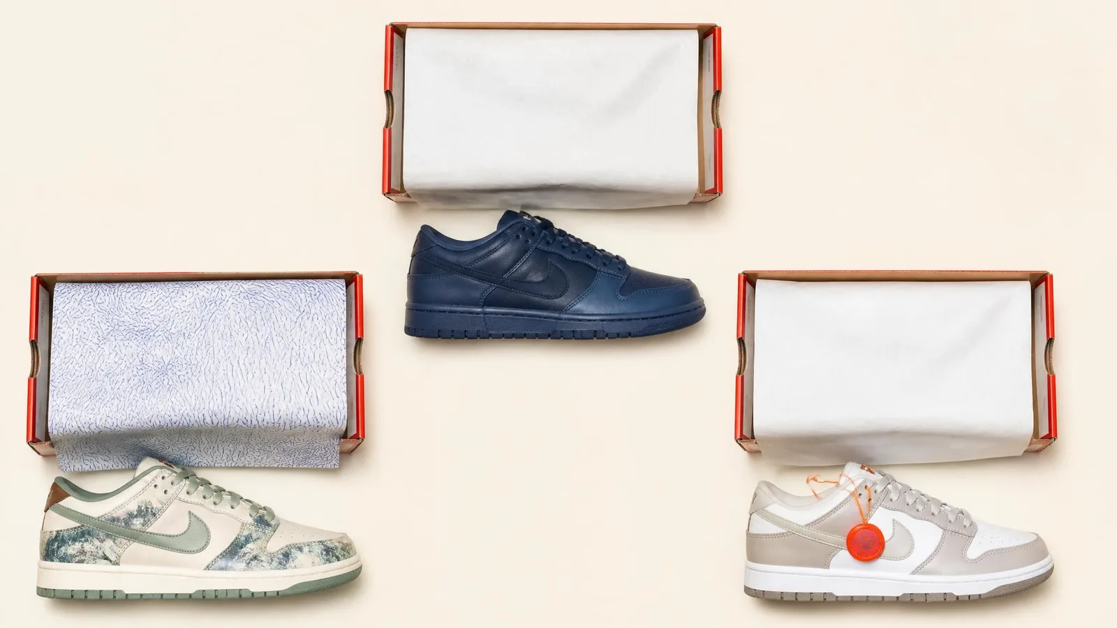 Three Nike Dunk pairs displayed beside their open boxes on a white surface, representing a general release, a pack release, and a collaboration with a hang tag visible, arranged in a clean catalogue-style flat-lay.