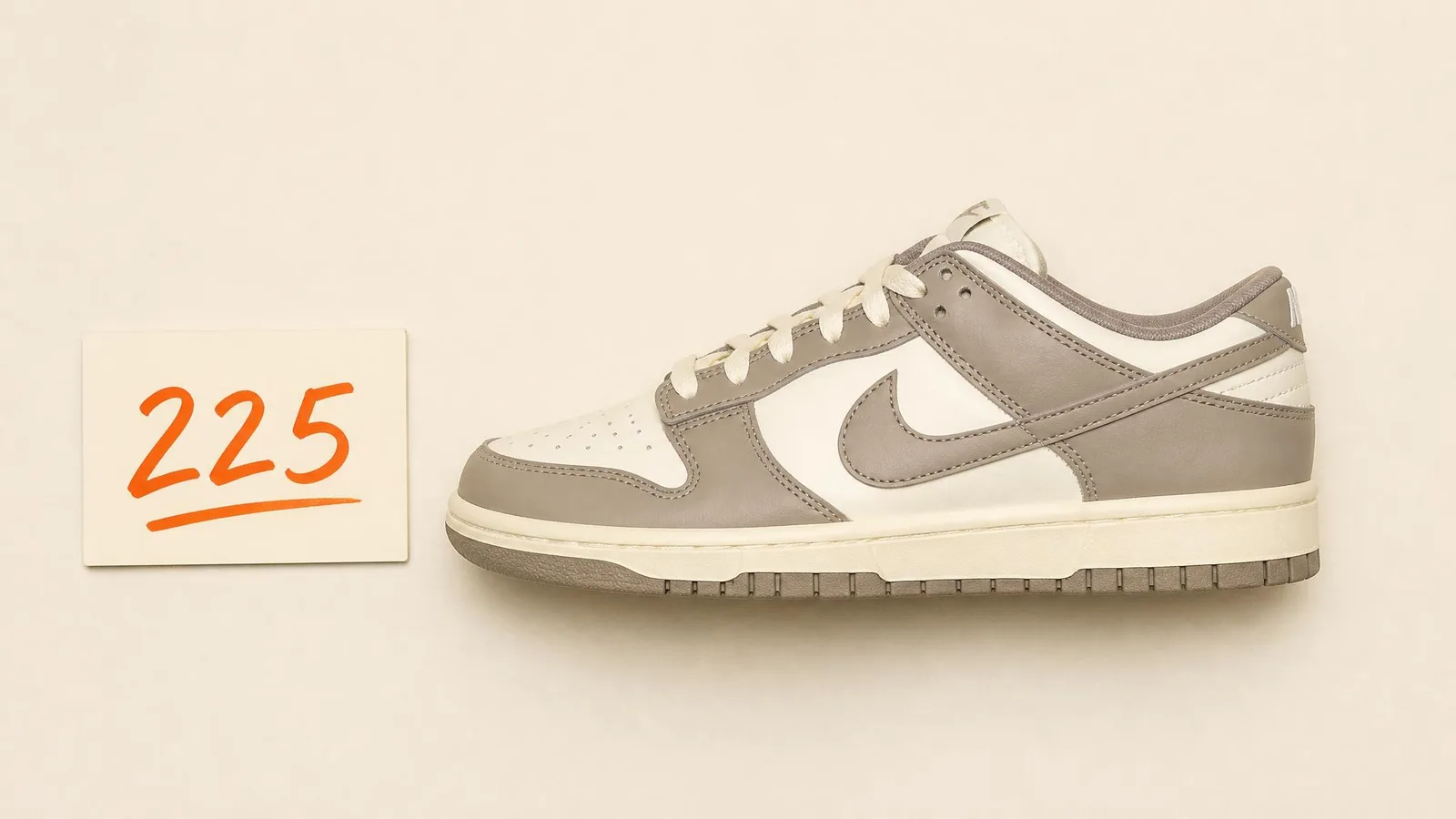 A studio side-profile shot of a clean deadstock sneaker on a warm cream surface beside a small burnt-orange price tag, shot with bright even lighting that highlights the sneaker's construction detail and communicates transparent, known value.