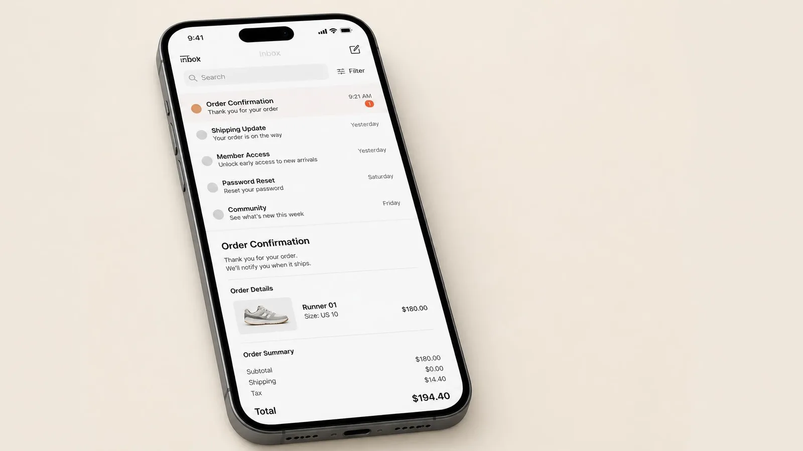 Smartphone lying flat showing an open order confirmation email with a sneaker model name, size and total cost visible, representing the process of searching email for purchase records.