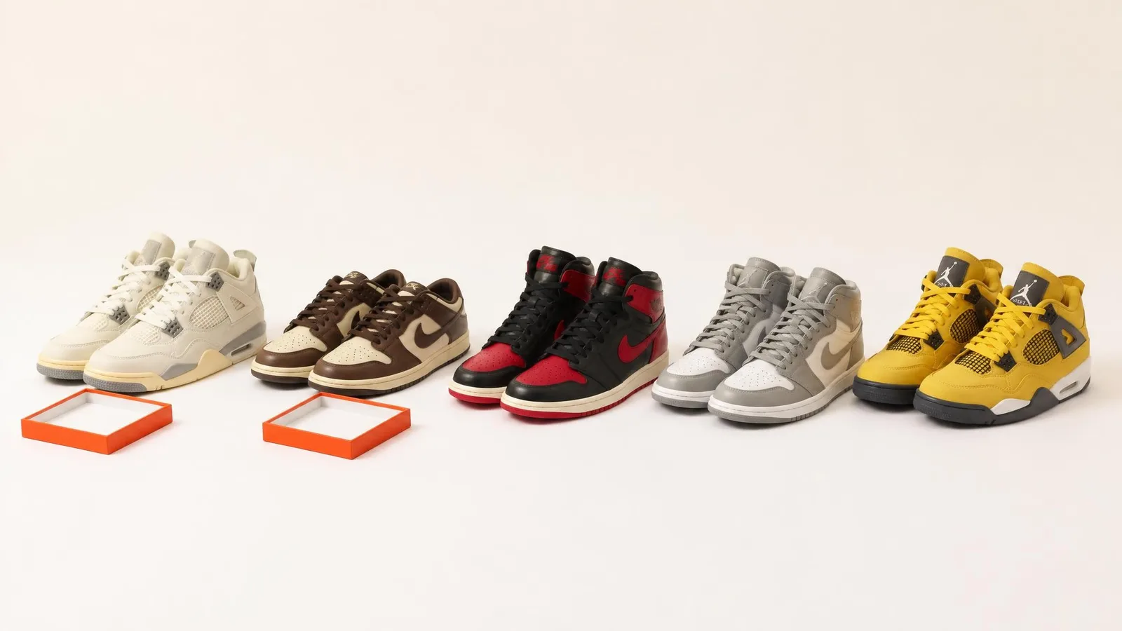 Five pairs of sneakers lined up in a studio row with orange box lids placed beside the first two pairs, illustrating the process of working through a collection in small, manageable batches.
