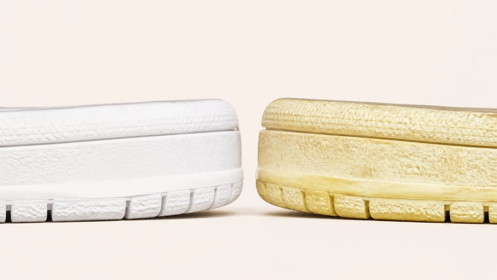 Side-by-side comparison of two sneaker midsoles — one bright white and one yellowed from UV exposure — illustrating how UV light degrades foam materials in storage.