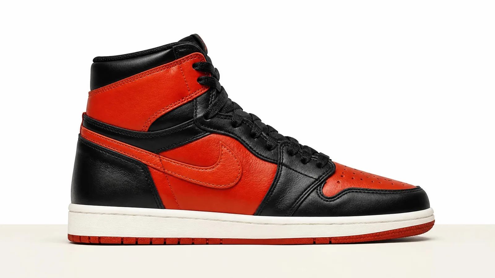 Air Jordan 1 high-top sneaker in black and red colorway shown in side profile against a white studio background.
