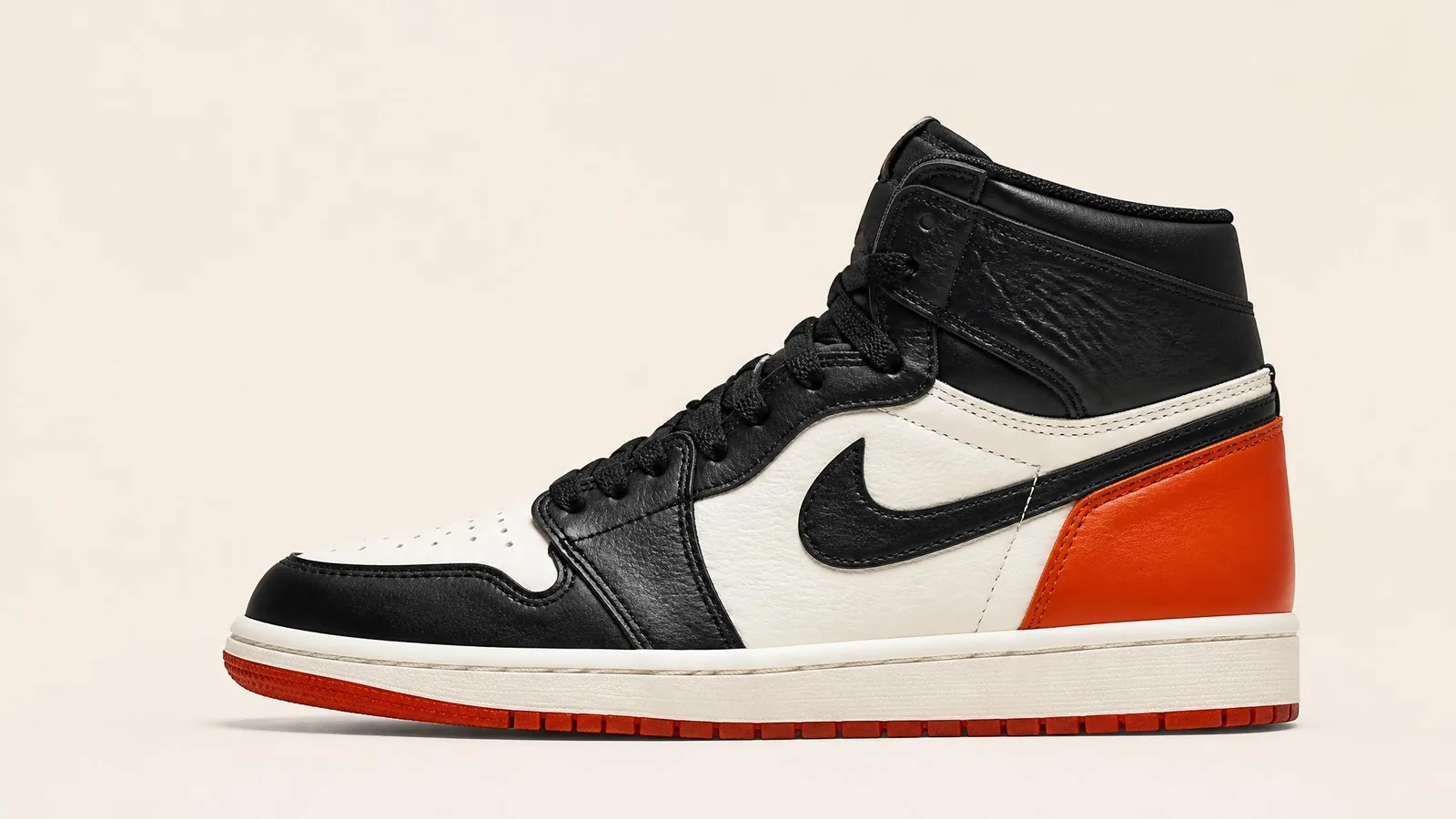 A single box-fresh high-top basketball sneaker in side profile against a clean off-white studio background, conveying careful collector appraisal.