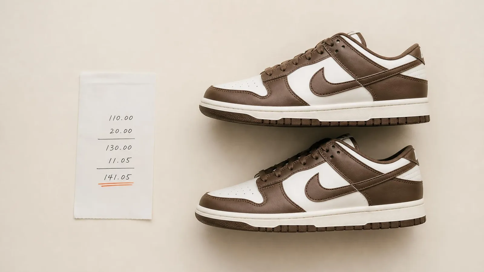 Overhead view of a Dunks sneaker in side-profile beside a purchase receipt on a warm off-white surface, with a burnt-orange accent underline on the cost figure, representing cost basis tracking for a sneaker collection record.