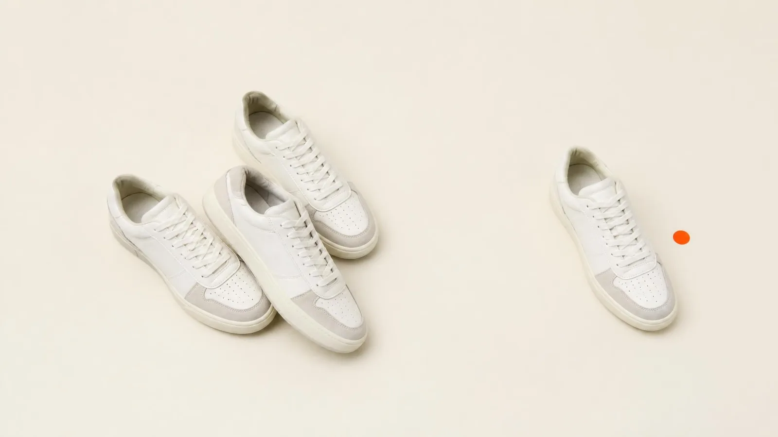A small group of identical sneakers arranged together on a pale surface with one shoe separated slightly from the cluster, representing the concept of thin transaction depth and how a single outlier sale can distort size-specific resale price estimates.