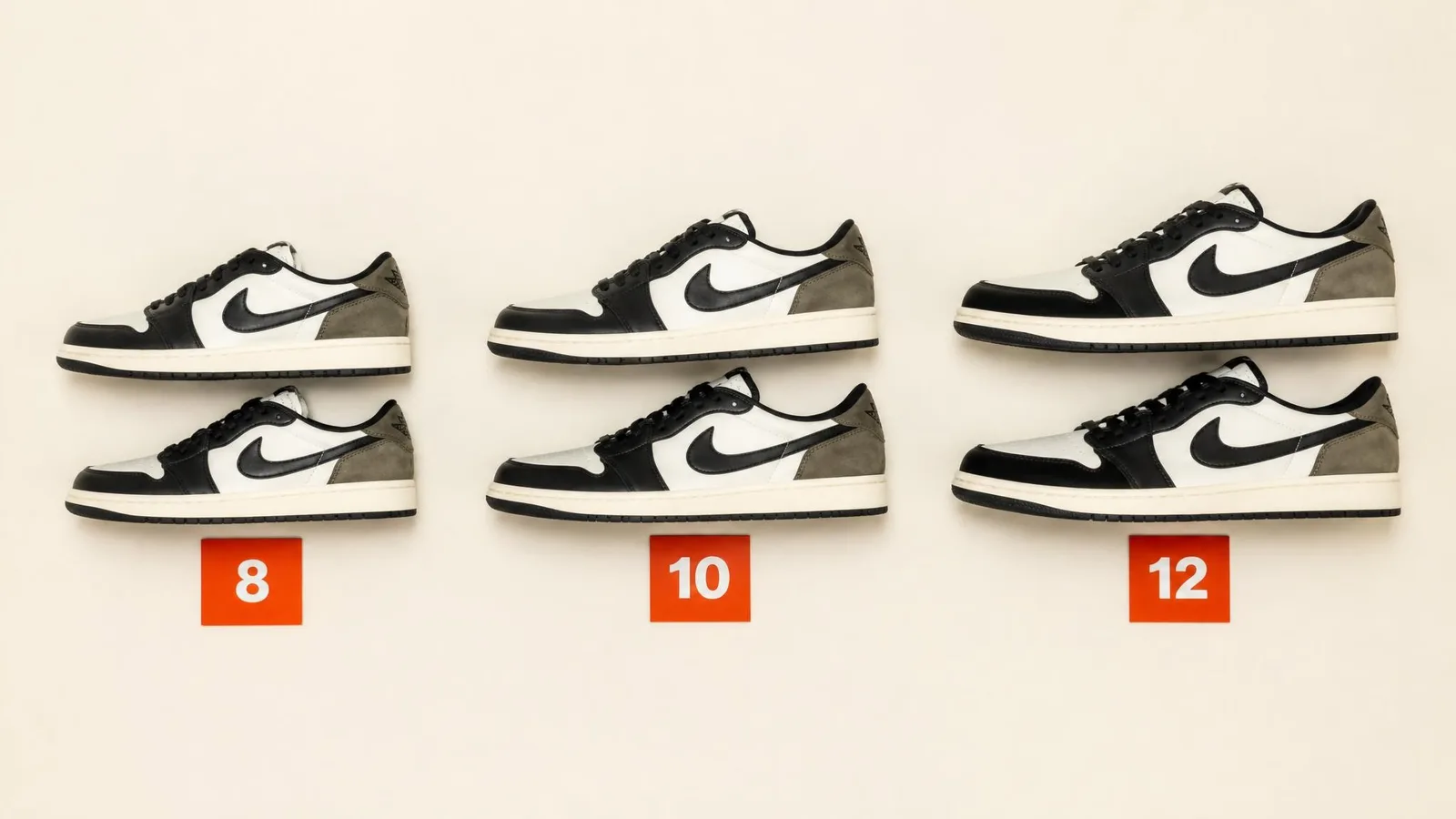 Three pairs of the same sneaker model in ascending sizes arranged in a flat-lay row on a cream surface, each accompanied by a small orange size label card showing numerals 8, 10, and 12.